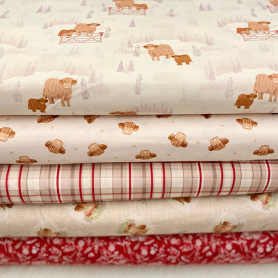 Stack of fabric sheets with highland cows and check patterns on a neutral background