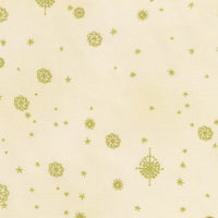 A close-up of a cream-colored fabric with a repeating pattern of small gold stars and floral snowflake motifs.