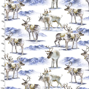 Digitally printed cotton fabric featuring reindeer with gold harnesses and mountains in the background.